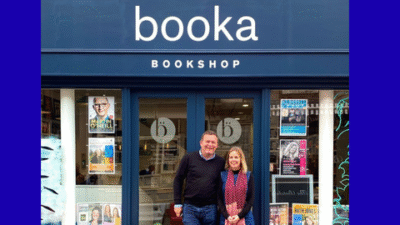 Booka shop front with Owners in front of it.