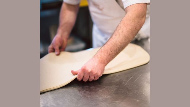 Baker rolling out dough