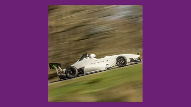 Racing car speeding up a hill with blurred background